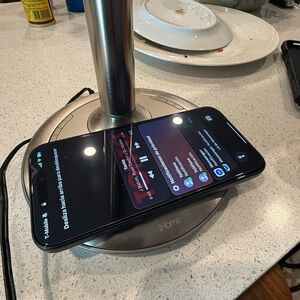 iHome Silver Wireless Charger with Black Smartphone